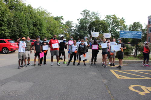 Volunteers cheer on runners on the last day of training on Dimock's campus